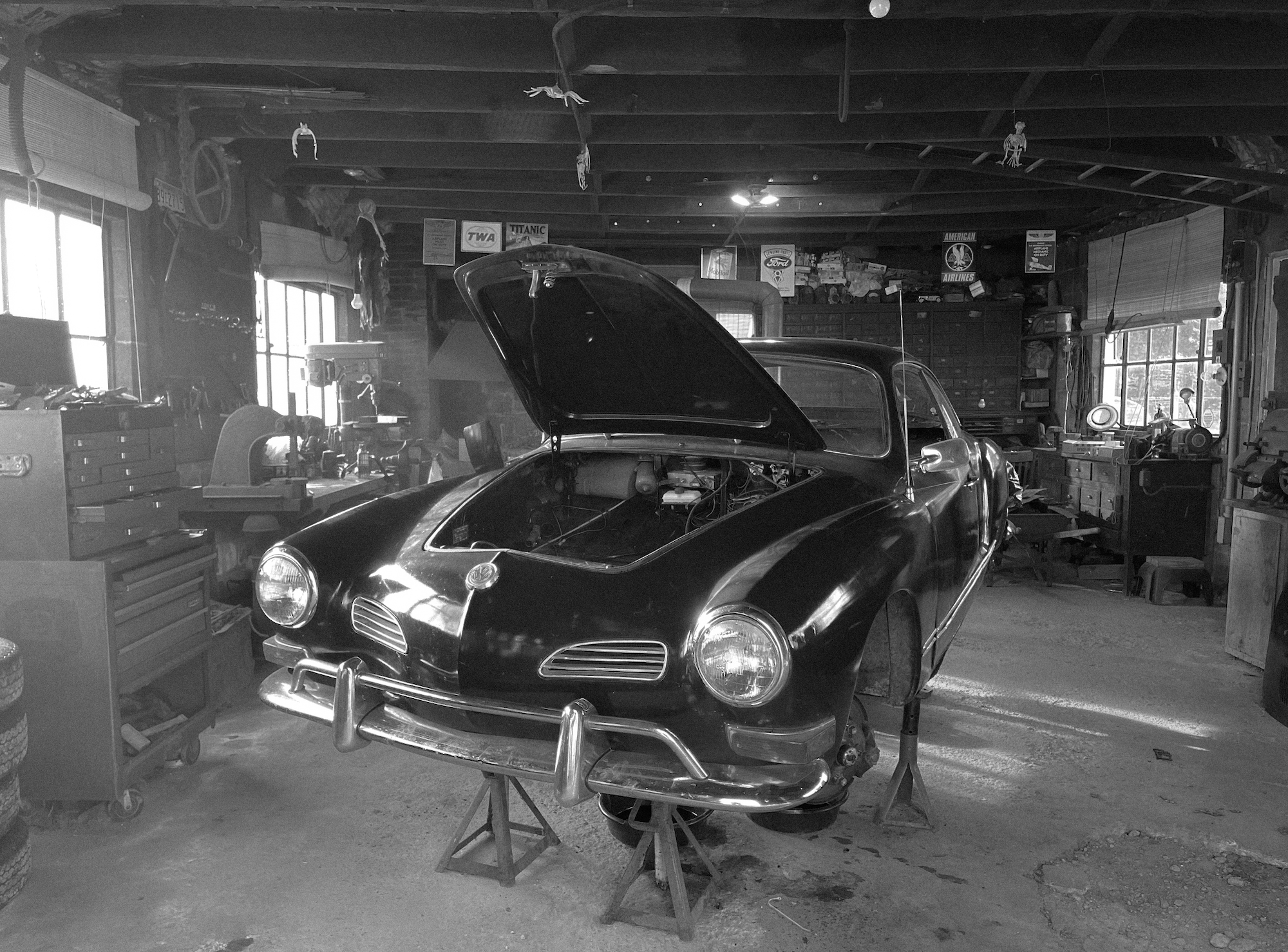 Karmann Ghia in the shop with the hood open during restoration.